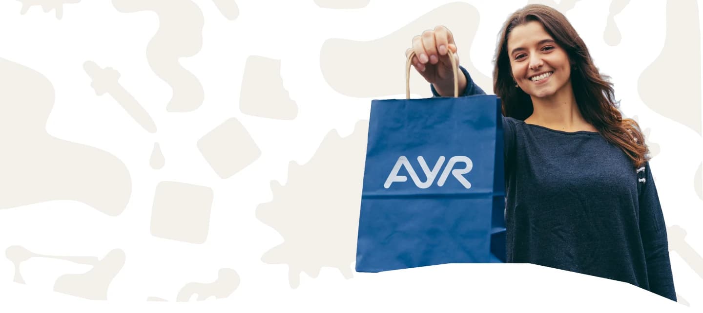 Smiling Ayr Wellness customer holding an AYR shopping bag, surrounded by decorative cannabis leaf illustrations